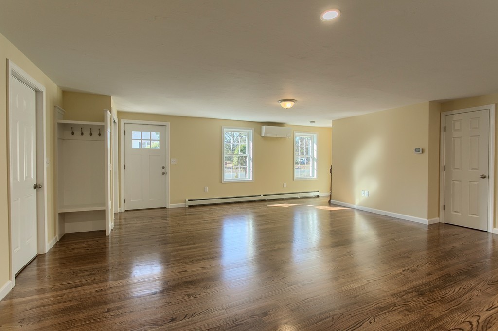 8 Shawnee Road, Unit B Pepperell, MA 01463 - Photo 4 of 18 a view of empty room with wooden floor and window