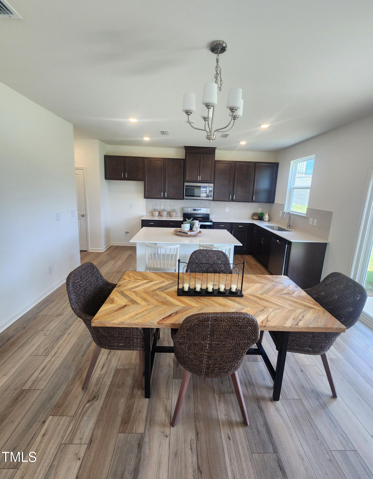 28 Longdale Drive Graham, NC 27253 - Photo 3 of 28 a view of a dining room with furniture a kitchen and chandelier