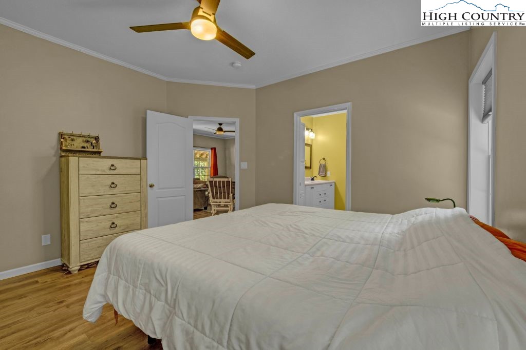 61 Snowbird Lane Linville, NC 28657 - Photo 8 of 19 a bedroom with a bed and a chandelier