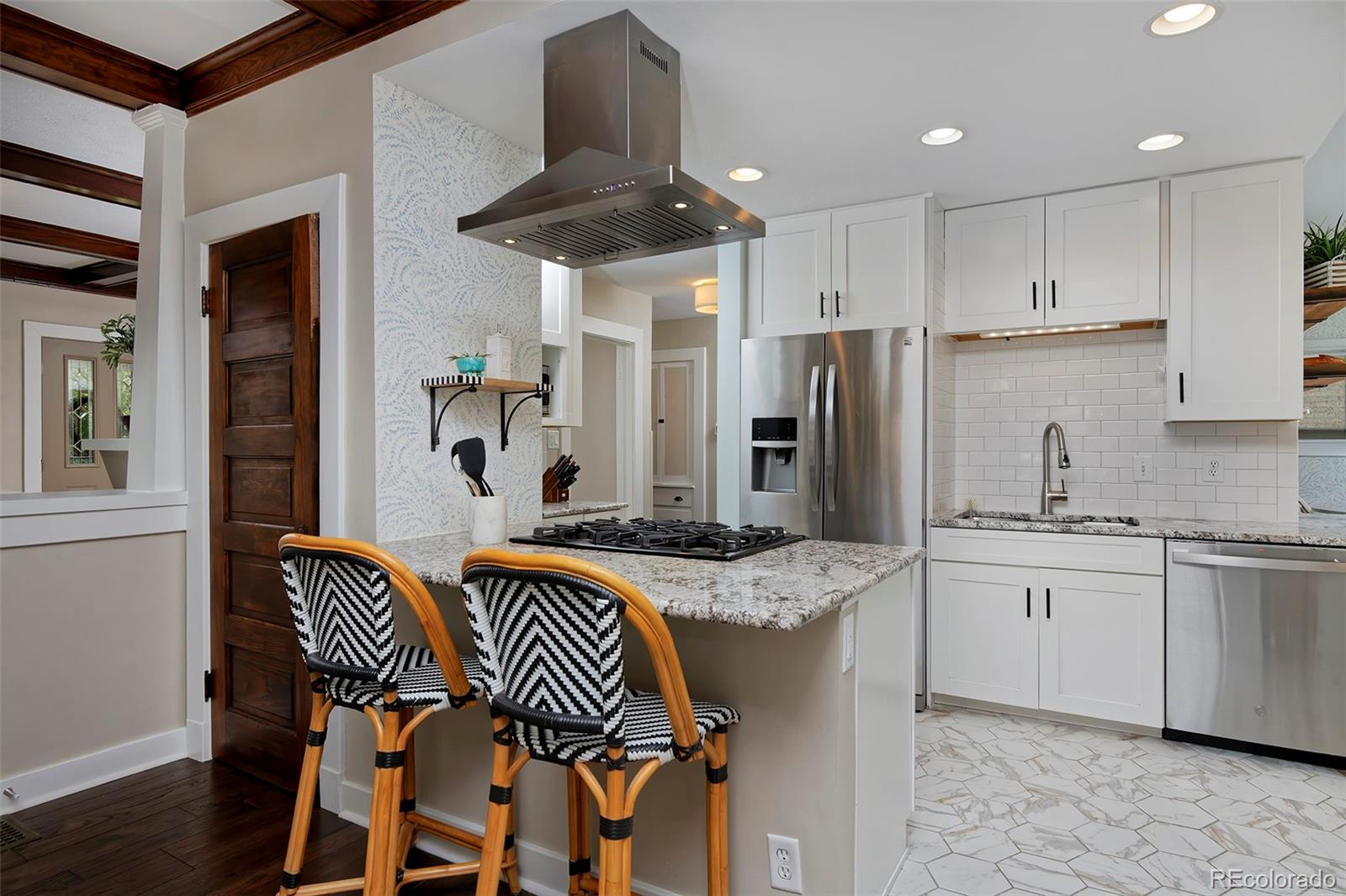 2591 Ash Street Denver, CO 80207 - Photo 13 of 48 a kitchen with stainless steel appliances granite countertop a sink and a refrigerator