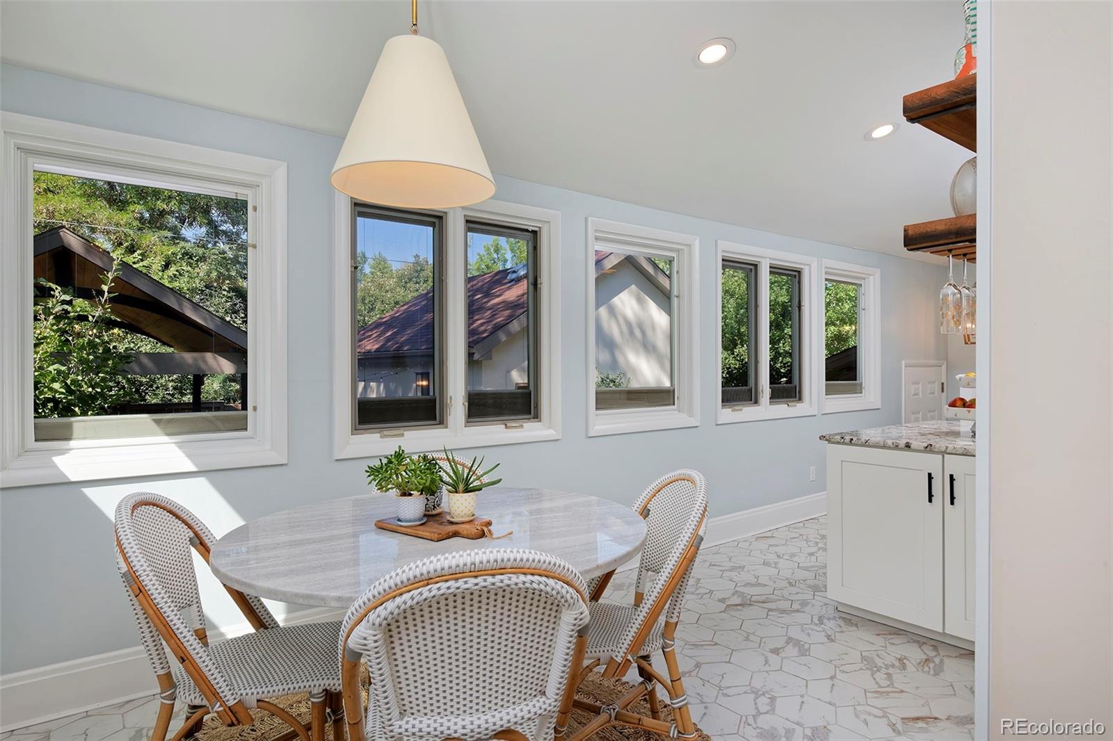 2591 Ash Street Denver, CO 80207 - Photo 19 of 48 a view of a dining room with furniture window and outside view