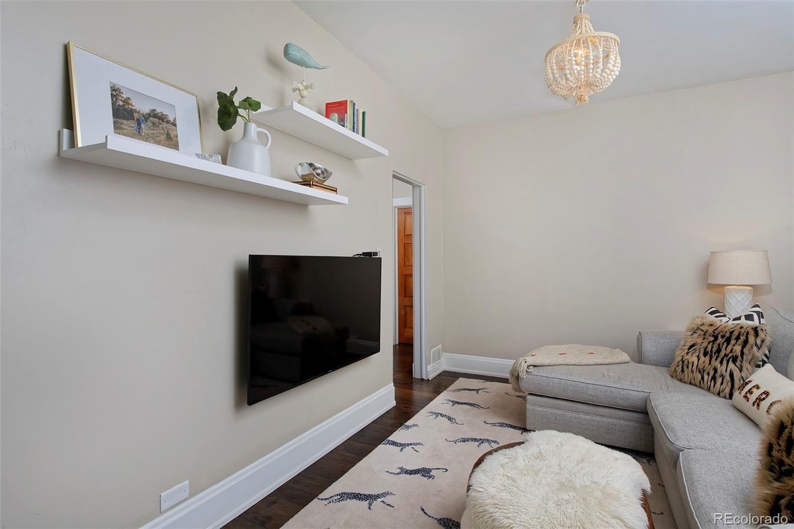 2591 Ash Street Denver, CO 80207 - Photo 21 of 48 a living room with furniture and a flat screen tv