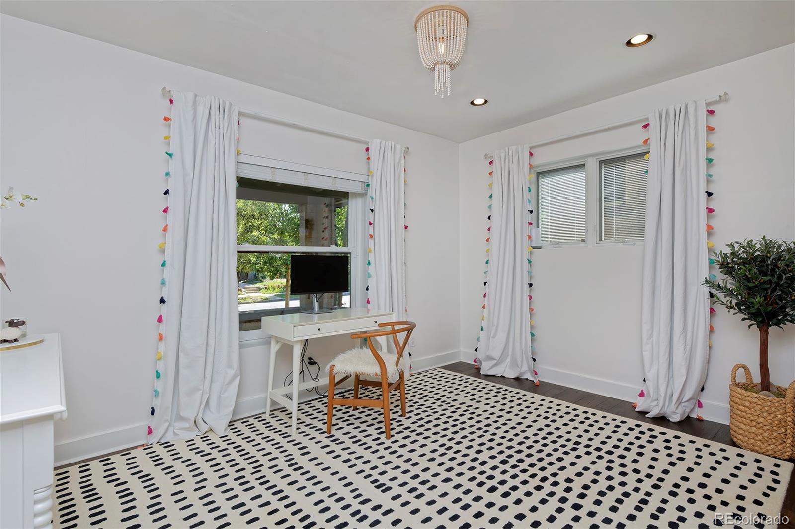 2591 Ash Street Denver, CO 80207 - Photo 23 of 48 a living room with a table and a potted plant