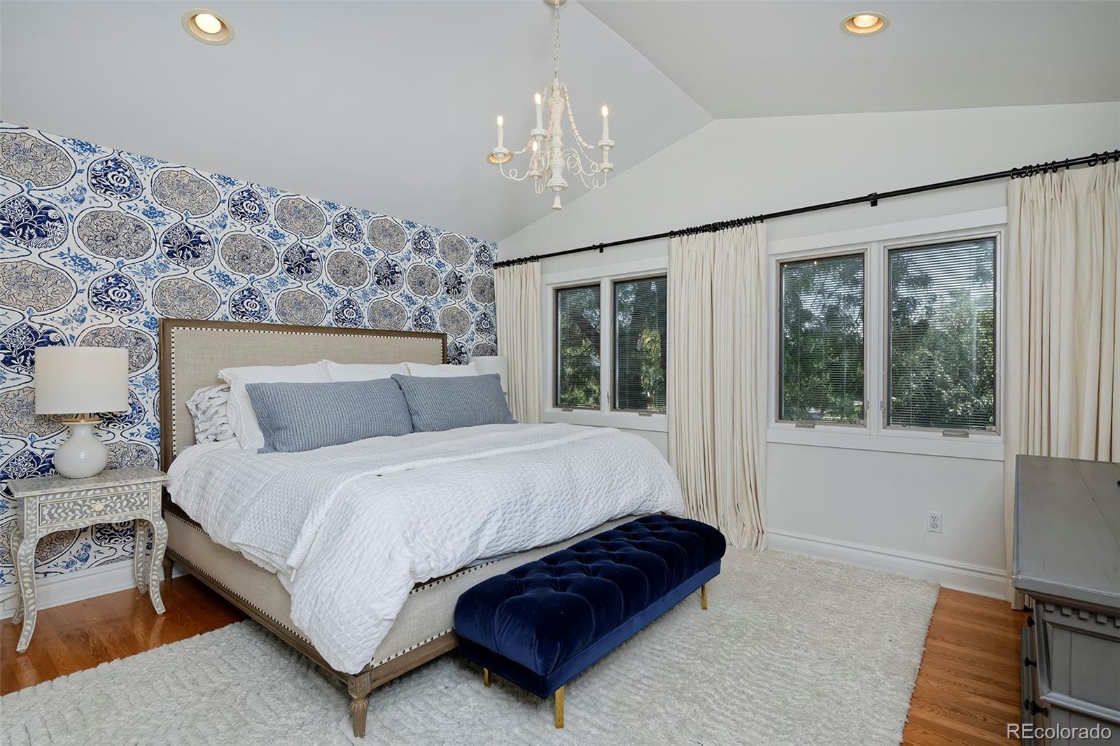 2591 Ash Street Denver, CO 80207 - Photo 25 of 48 a spacious bedroom with a large bed and a chandelier