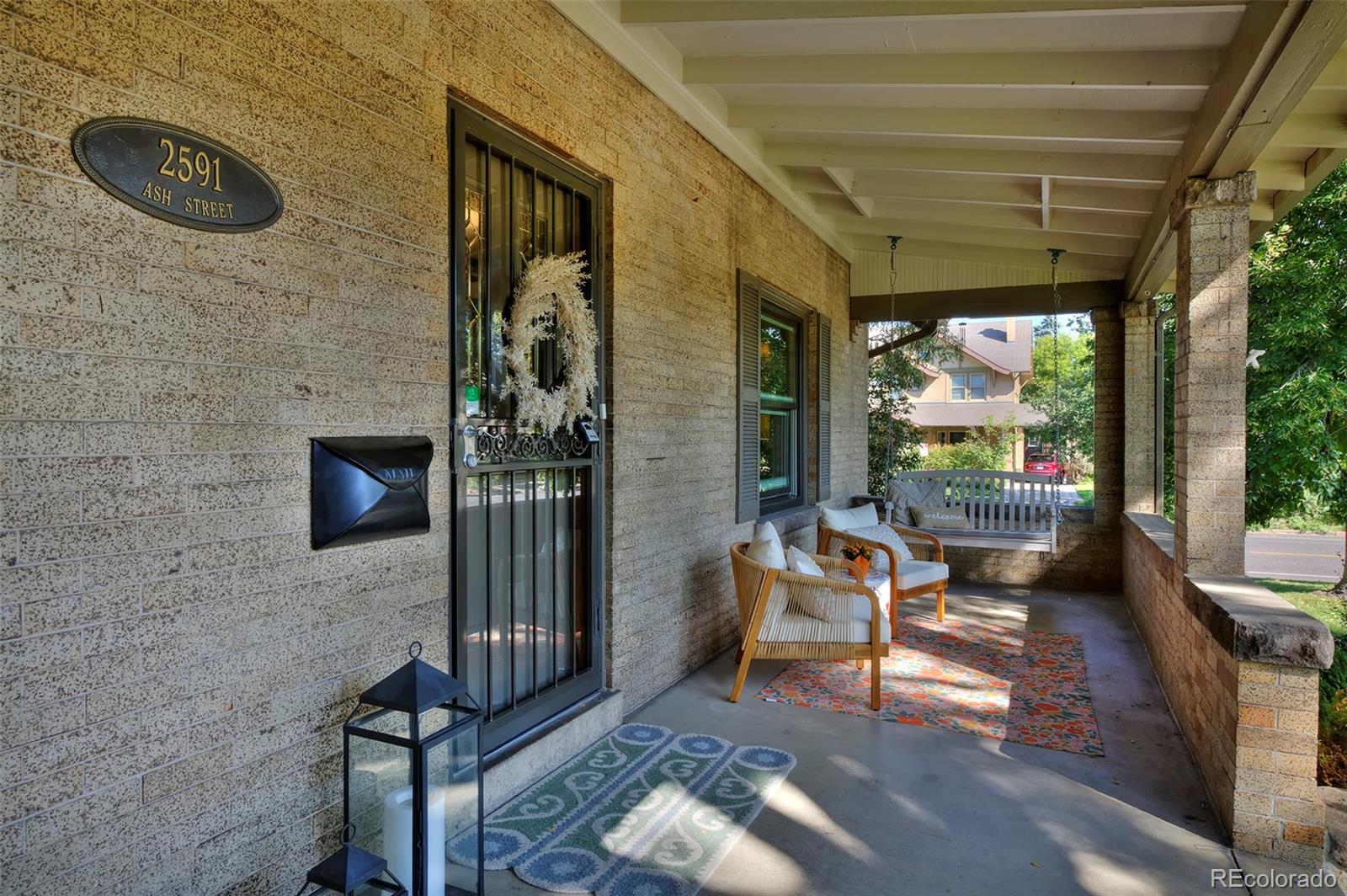 2591 Ash Street Denver, CO 80207 - Photo 3 of 48 a backyard of a house with outdoor seating
