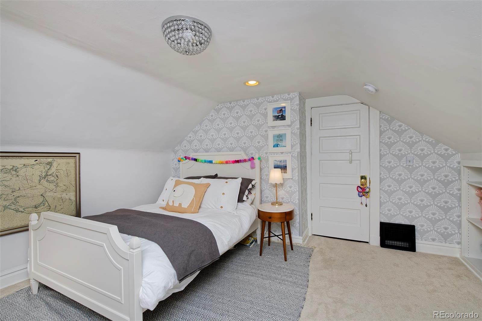 2591 Ash Street Denver, CO 80207 - Photo 31 of 48 a bedroom with a bed and a table