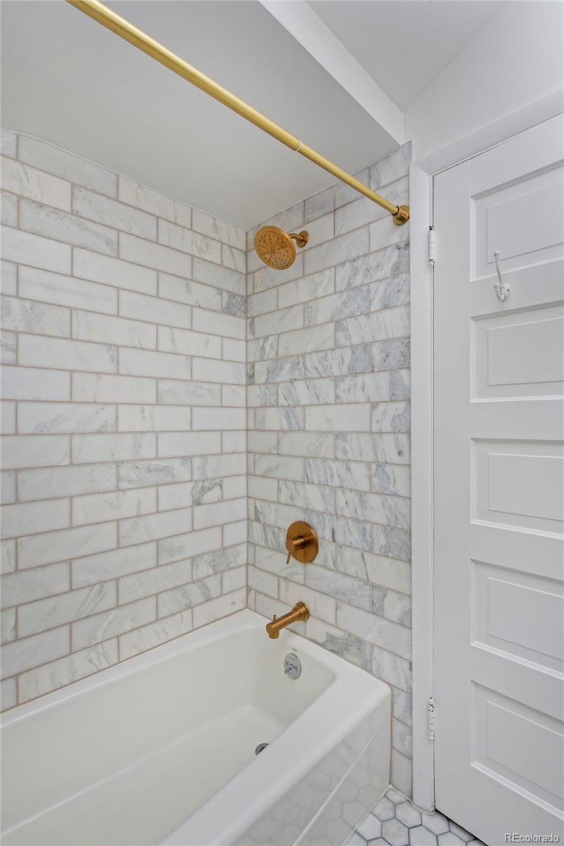 2591 Ash Street Denver, CO 80207 - Photo 34 of 48 a bathroom with a bathtub and a shower