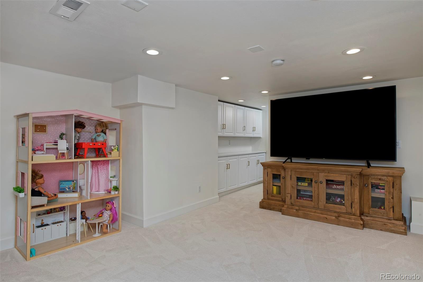 2591 Ash Street Denver, CO 80207 - Photo 36 of 48 a living room with furniture and a flat screen tv