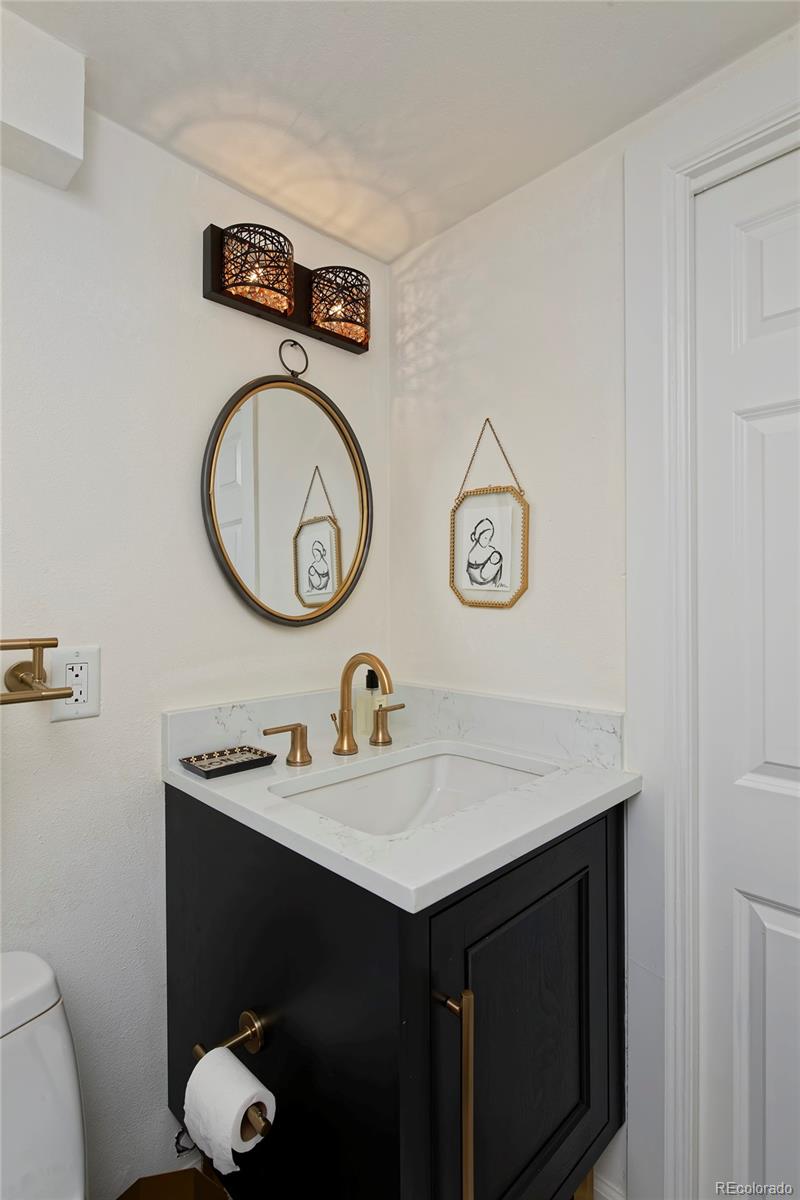 2591 Ash Street Denver, CO 80207 - Photo 40 of 48 a bathroom with a sink and a mirror