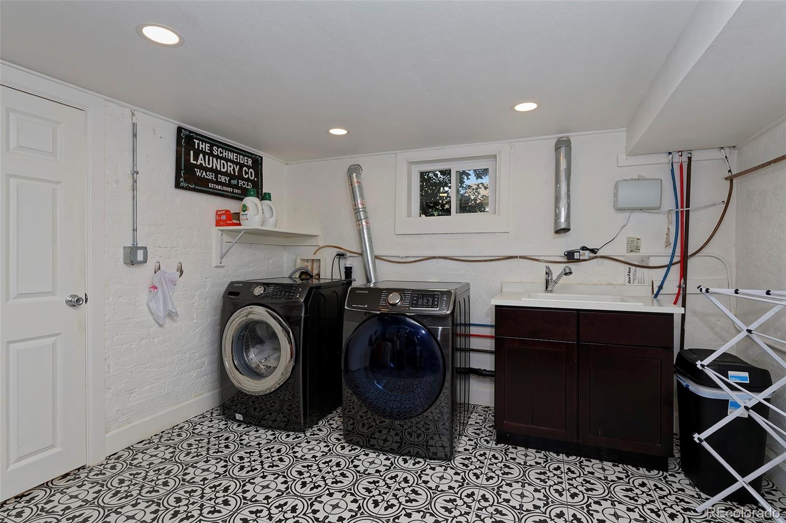 2591 Ash Street Denver, CO 80207 - Photo 41 of 48 a utility room with sink dryer and washer