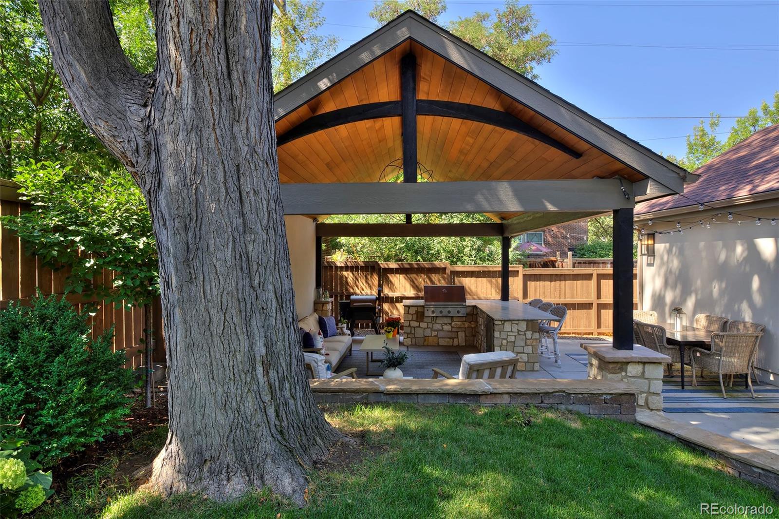 2591 Ash Street Denver, CO 80207 - Photo 43 of 48 a view of a patio with table and chairs potted plants and floor to ceiling window