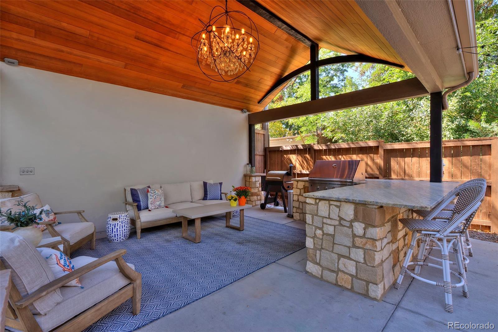 2591 Ash Street Denver, CO 80207 - Photo 45 of 48 a outdoor space with the couches and dining table with the view of garden