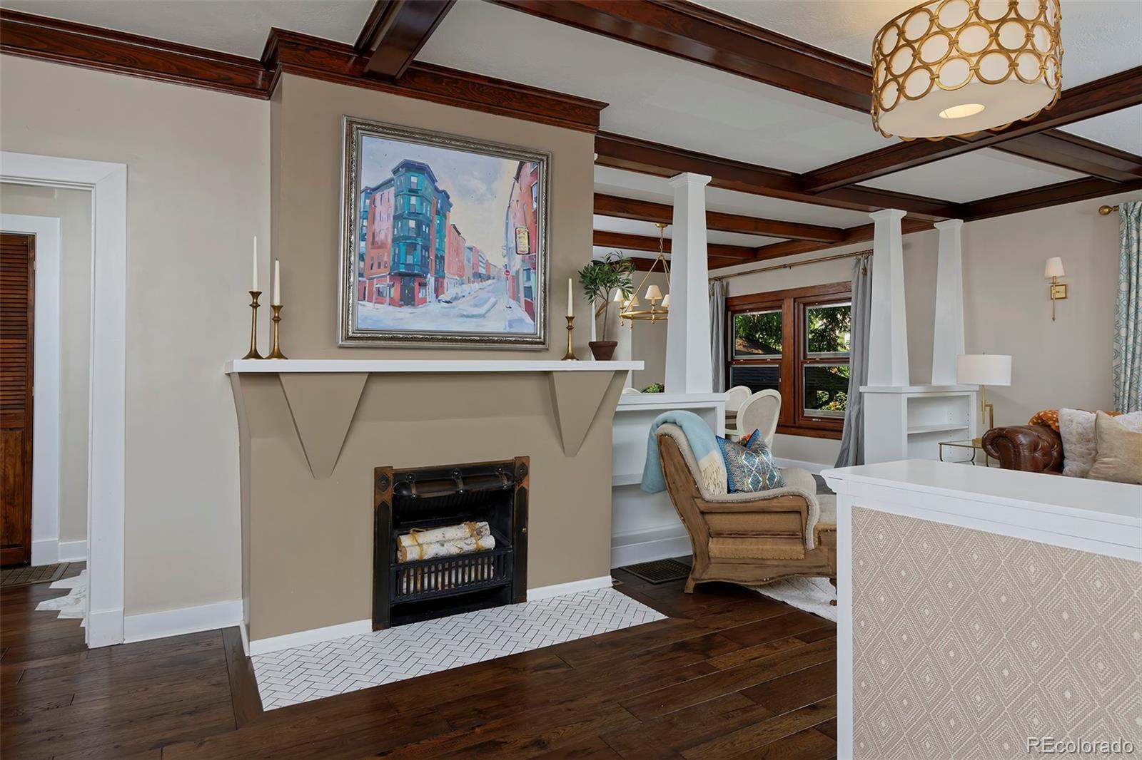 2591 Ash Street Denver, CO 80207 - Photo 6 of 48 a living room with furniture a fireplace and a table