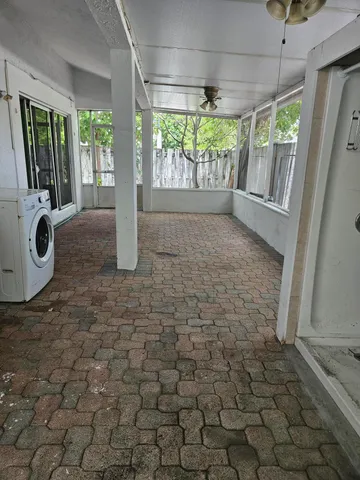 a kitchen with a sink dishwasher stove and cabinets