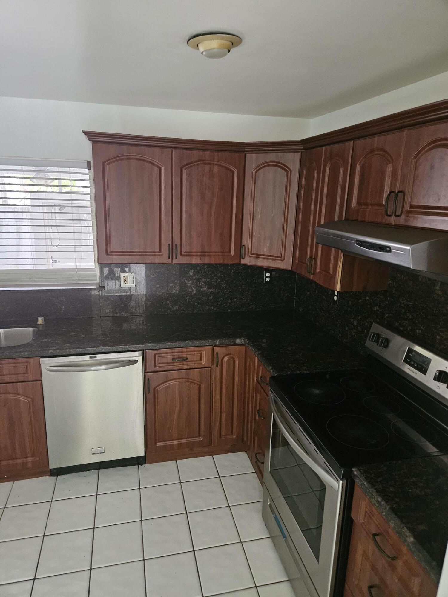 21109 Northeast 3rd Court Miami, FL 33179 - Photo 17 of 30 a kitchen with a sink dishwasher stove and cabinets
