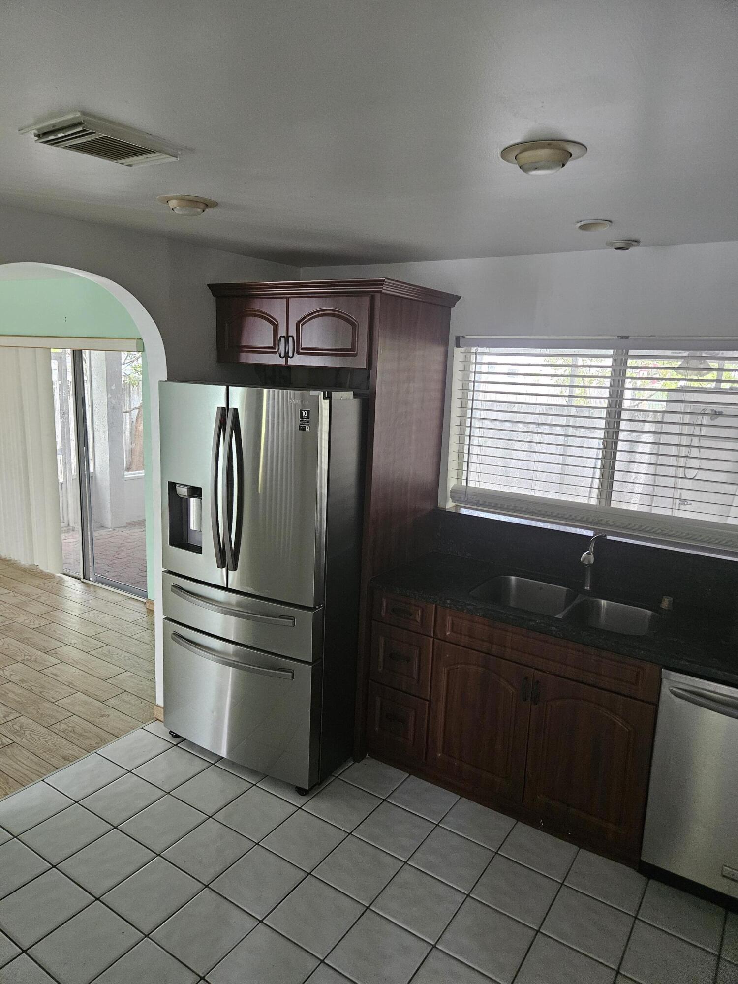 21109 Northeast 3rd Court Miami, FL 33179 - Photo 18 of 30 a kitchen with a refrigerator and a sink