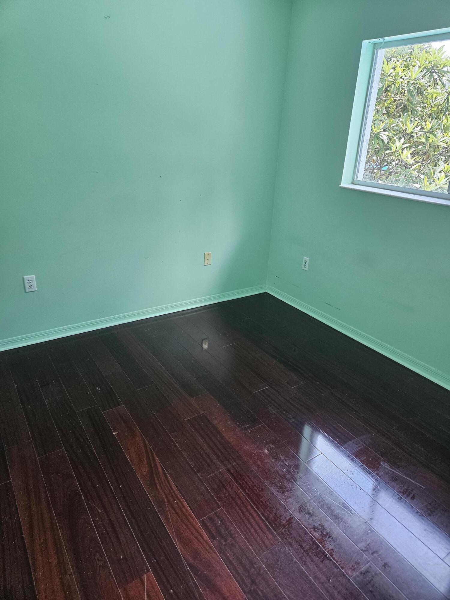 21109 Northeast 3rd Court Miami, FL 33179 - Photo 20 of 30 a view of room with window and wooden floor