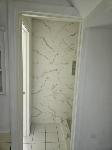 a view of a small space with wooden floor and a window