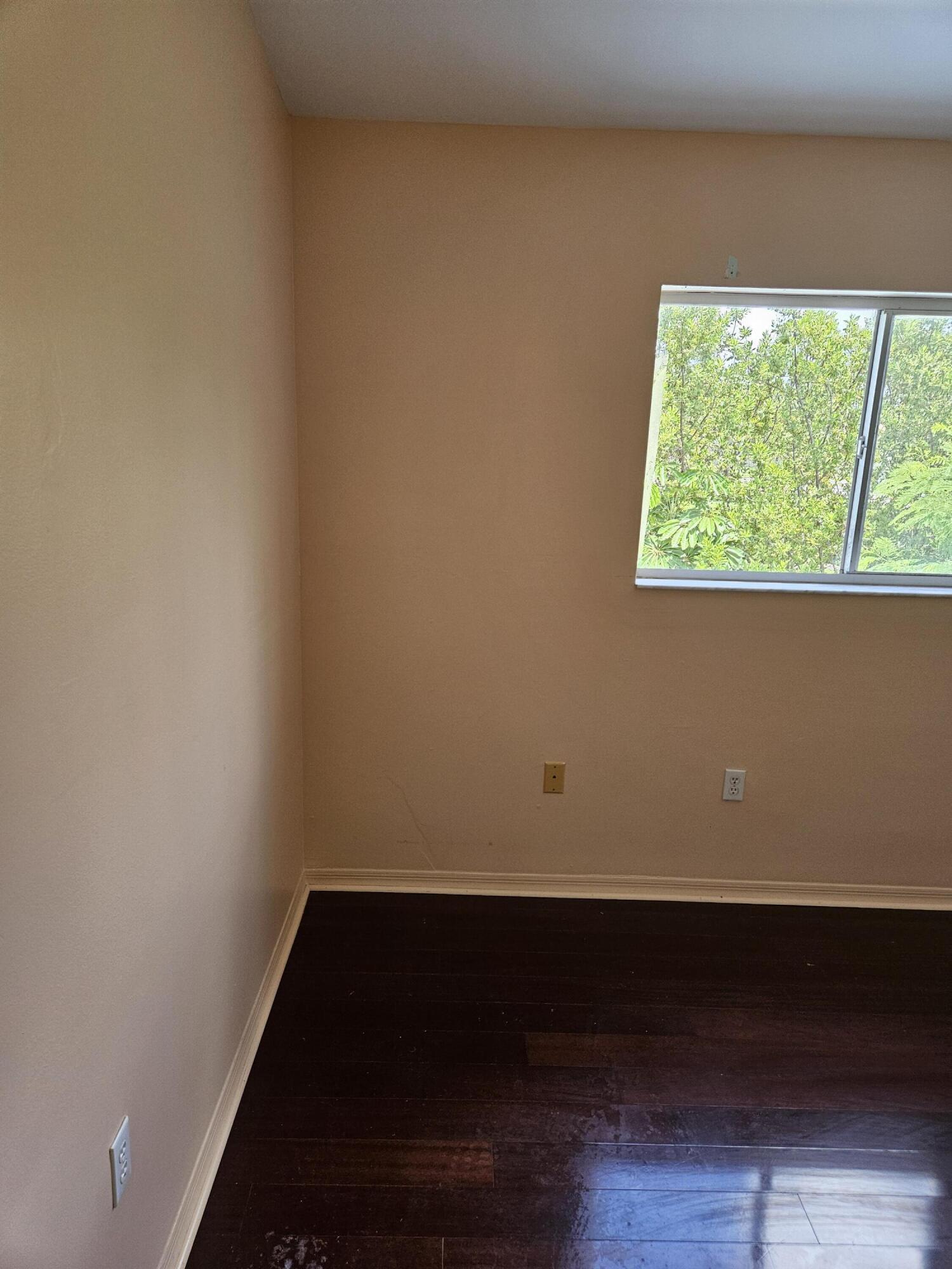 21109 Northeast 3rd Court Miami, FL 33179 - Photo 24 of 30 a view of a small space with wooden floor and a window