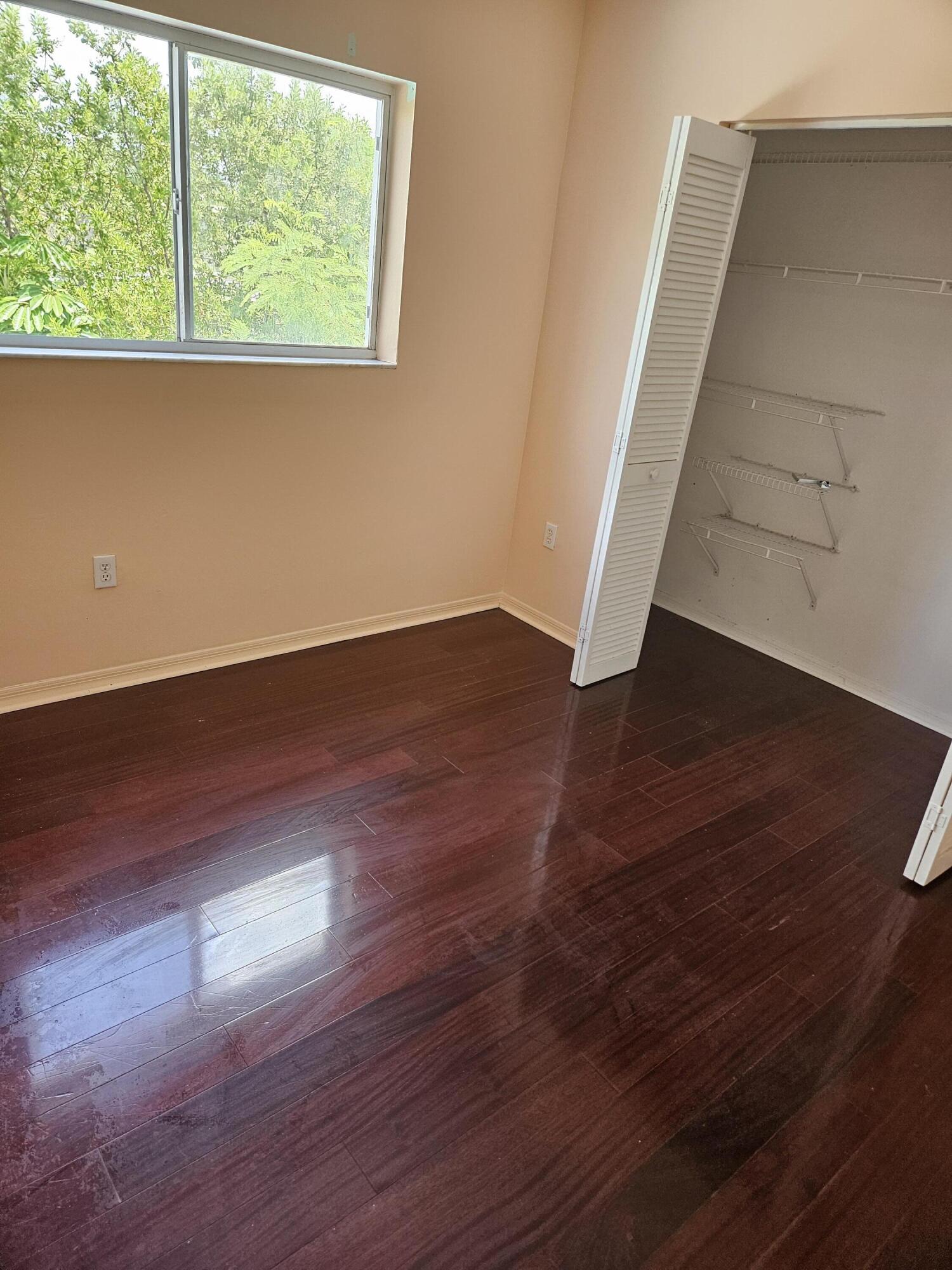 21109 Northeast 3rd Court Miami, FL 33179 - Photo 25 of 30 an empty room with wooden floor and windows