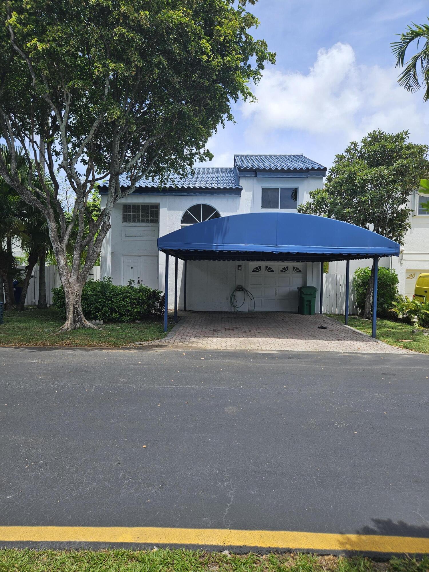 21109 Northeast 3rd Court Miami, FL 33179 - Photo 4 of 30 a front view of a house with a yard and garage