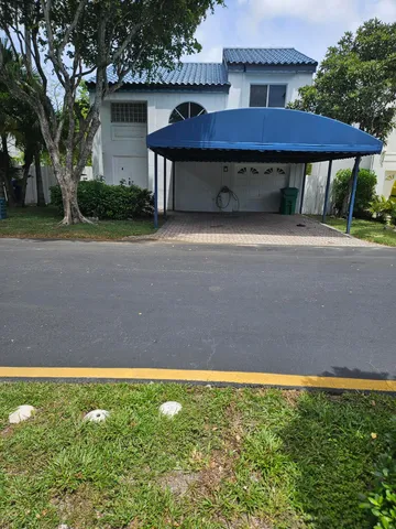 a view of a house with a backyard and a patio