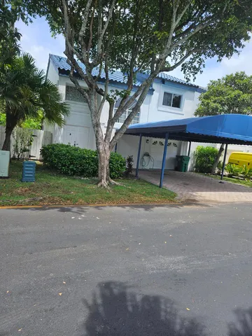 a front view of a house with yard and green space