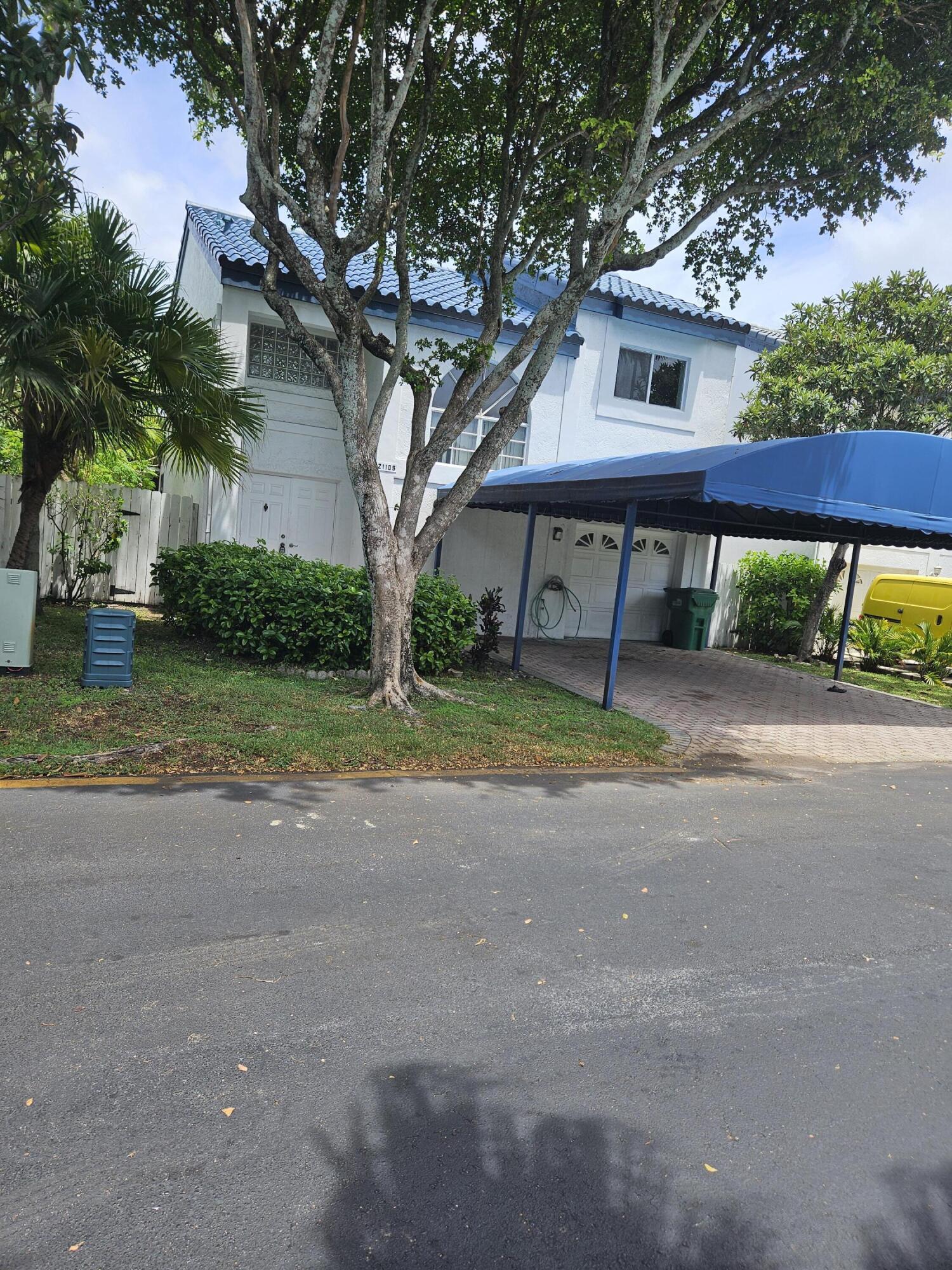 21109 Northeast 3rd Court Miami, FL 33179 - Photo 6 of 30 a front view of a house with yard and green space