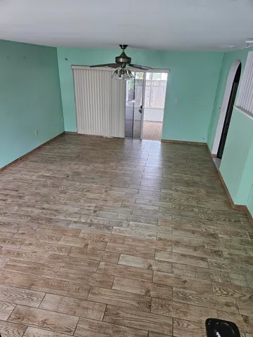 a view of a hallway with brick walls and a chandelier