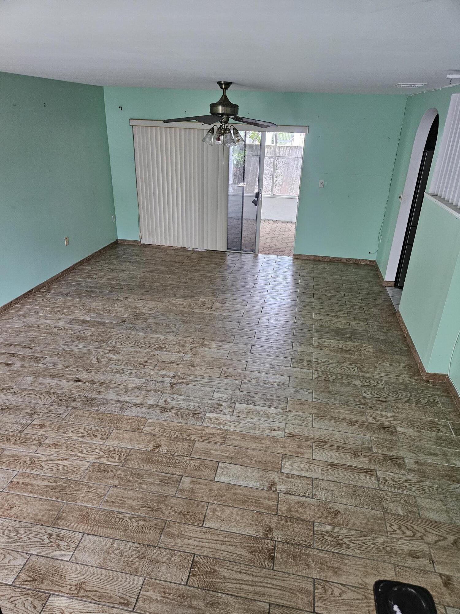 21109 Northeast 3rd Court Miami, FL 33179 - Photo 7 of 30 a view of a hallway with brick walls and a chandelier