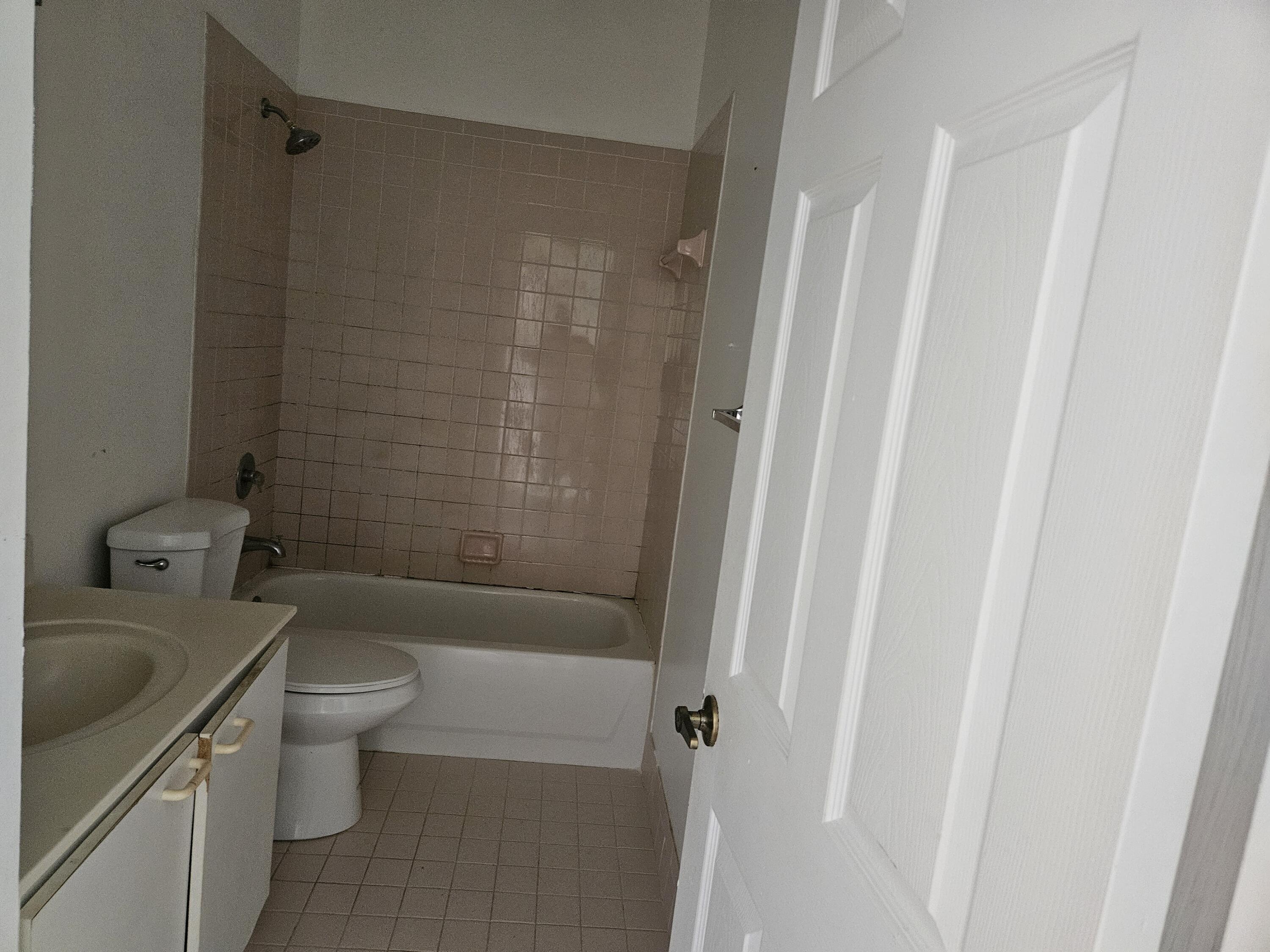 21109 Northeast 3rd Court Miami, FL 33179 - Photo 9 of 30 a bathroom with a sink a toilet and shower