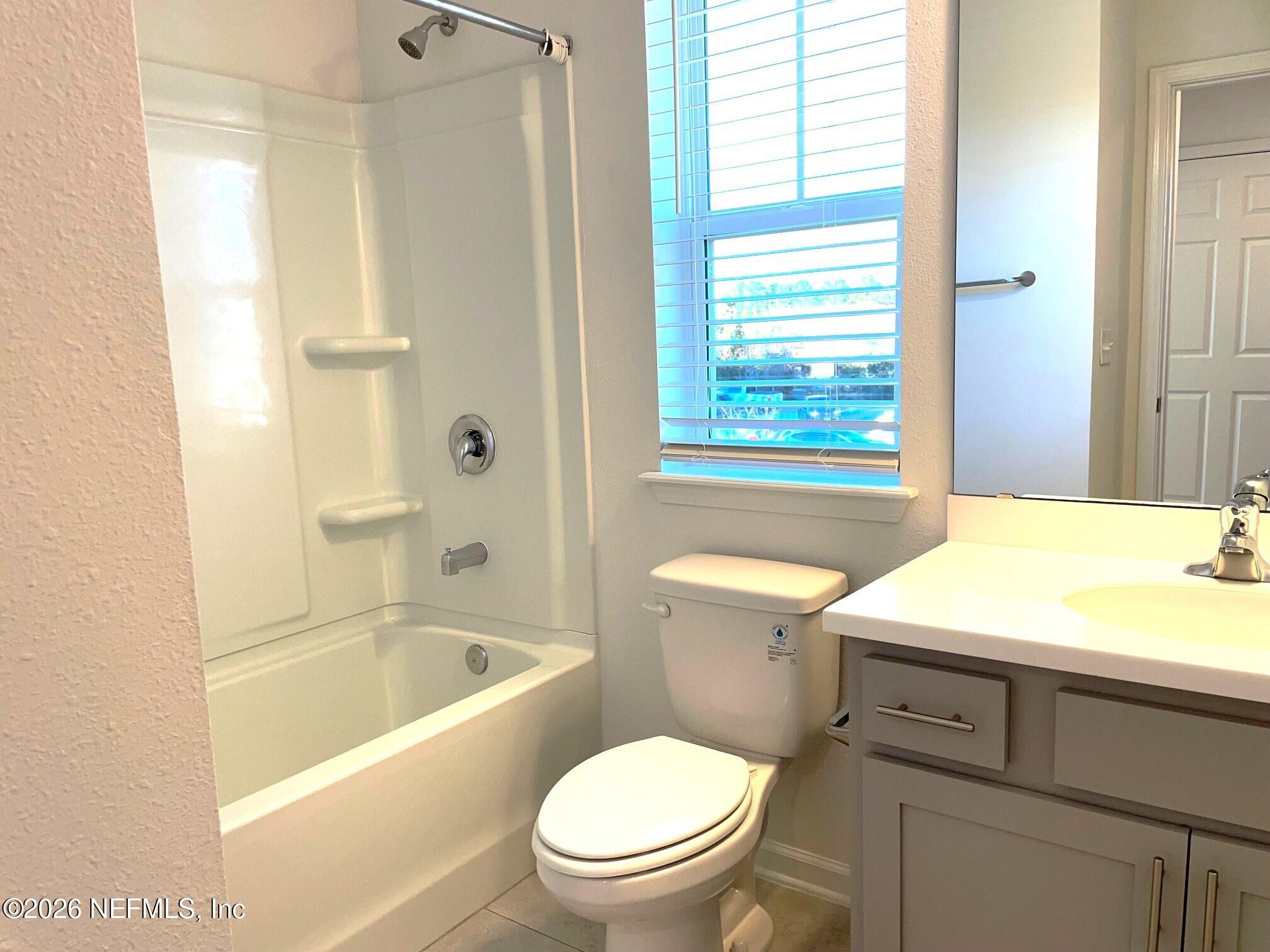 106 Ridge Lake Rd Street St. Augustine, FL 32086 - Photo 21 of 31 a bathroom with a granite countertop toilet a sink and a bathtub