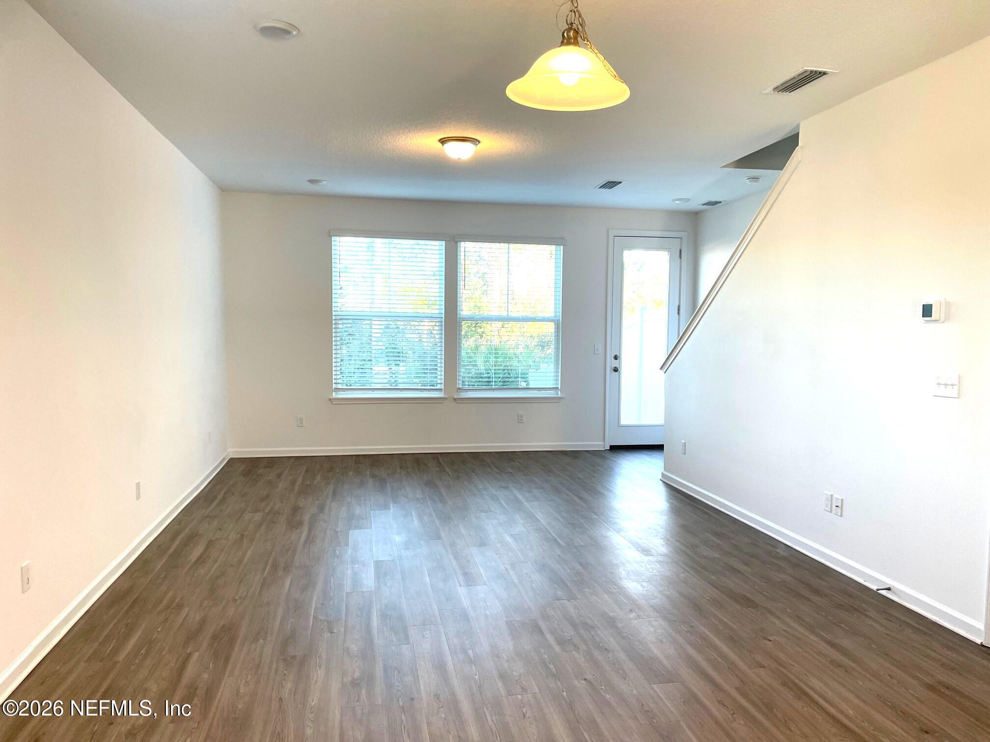 106 Ridge Lake Rd Street St. Augustine, FL 32086 - Photo 10 of 31 a view of an empty room with wooden floor and a window