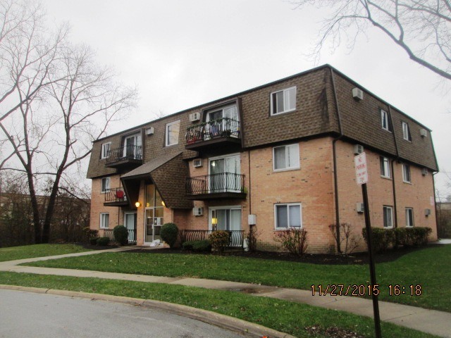 4809 West Engle Road, Unit 2B Alsip, IL 60803 - Photo 2 of 12 a front view of a building with a garden