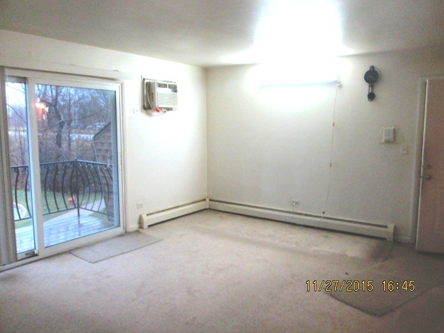 4809 West Engle Road, Unit 2B Alsip, IL 60803 - Photo 3 of 12 a view of empty room with sliding door