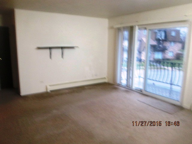 4809 West Engle Road, Unit 2B Alsip, IL 60803 - Photo 4 of 12 an empty room with sliding door