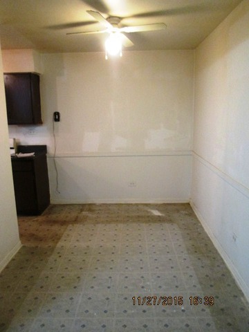 4809 West Engle Road, Unit 2B Alsip, IL 60803 - Photo 5 of 12 a view of a refrigerator in an empty room