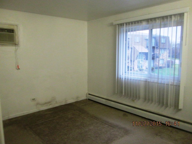 4809 West Engle Road, Unit 2B Alsip, IL 60803 - Photo 8 of 12 an empty room with wooden floor and windows