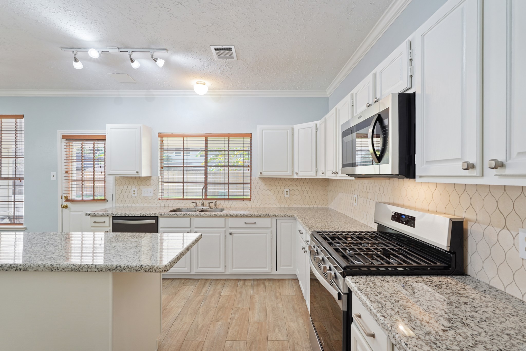 a kitchen with granite countertop a stove and a sink