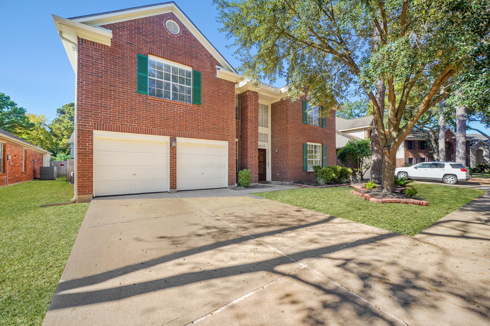 16215 Wemyss Bay Road Houston, TX 77095 - Photo 11 of 44 a front view of a house with a yard and garage