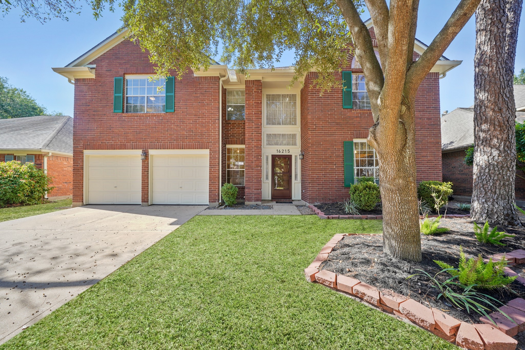 16215 Wemyss Bay Road Houston, TX 77095 - Photo 19 of 44 a front view of a house with garden