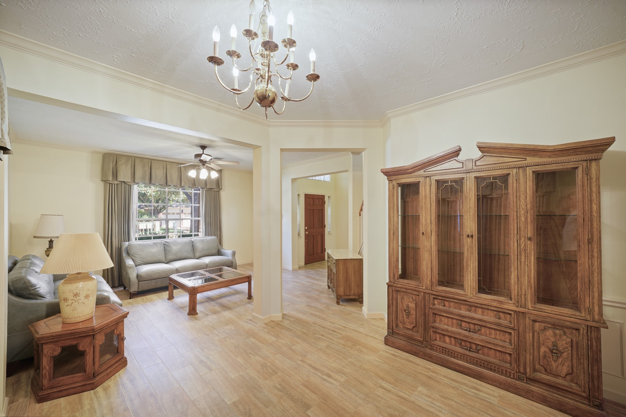 16215 Wemyss Bay Road Houston, TX 77095 - Photo 23 of 44 a living room with furniture chandelier and a window