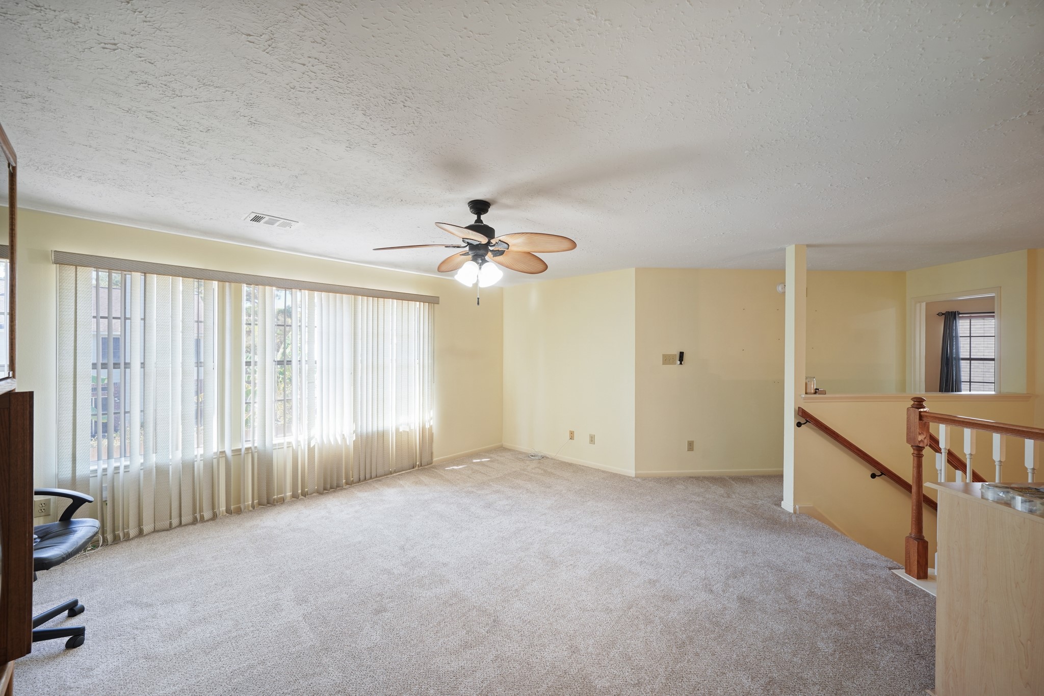 16215 Wemyss Bay Road Houston, TX 77095 - Photo 30 of 44 an empty room with chandelier fan and windows