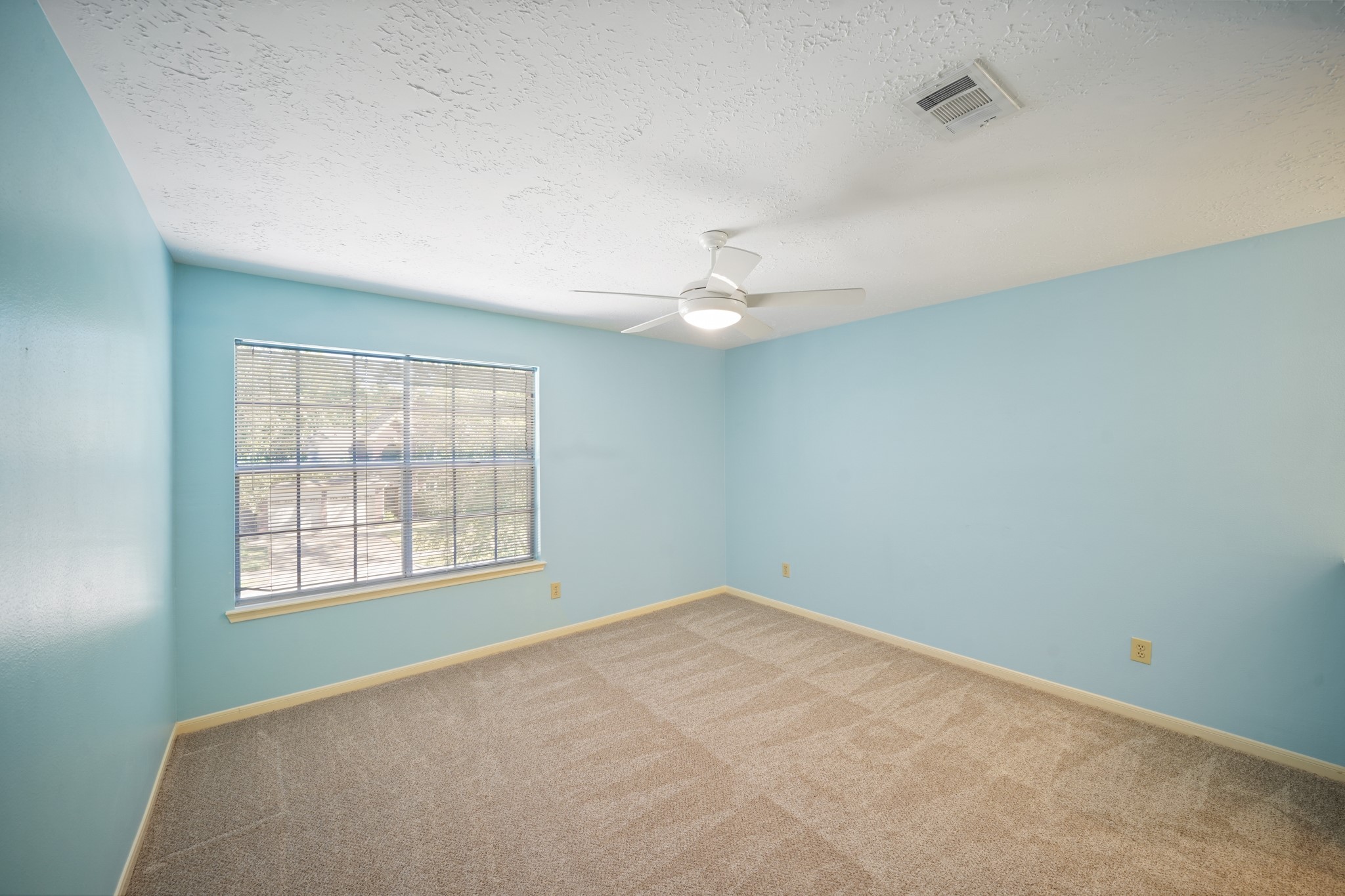 16215 Wemyss Bay Road Houston, TX 77095 - Photo 36 of 44 an empty room with windows and fan