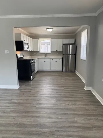 a view of kitchen with wooden floor