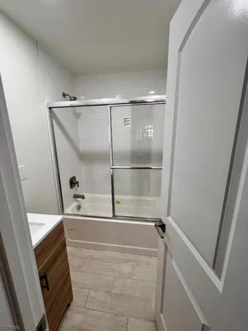 a bathroom with a tub and shower