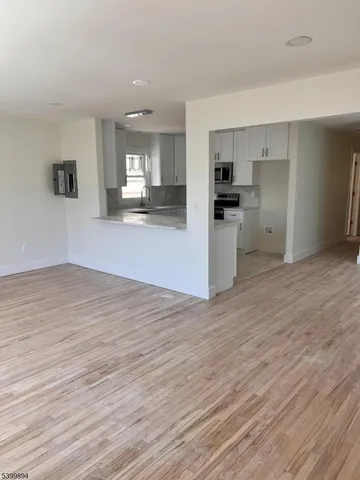 a view of kitchen with cabinets and wooden floor
