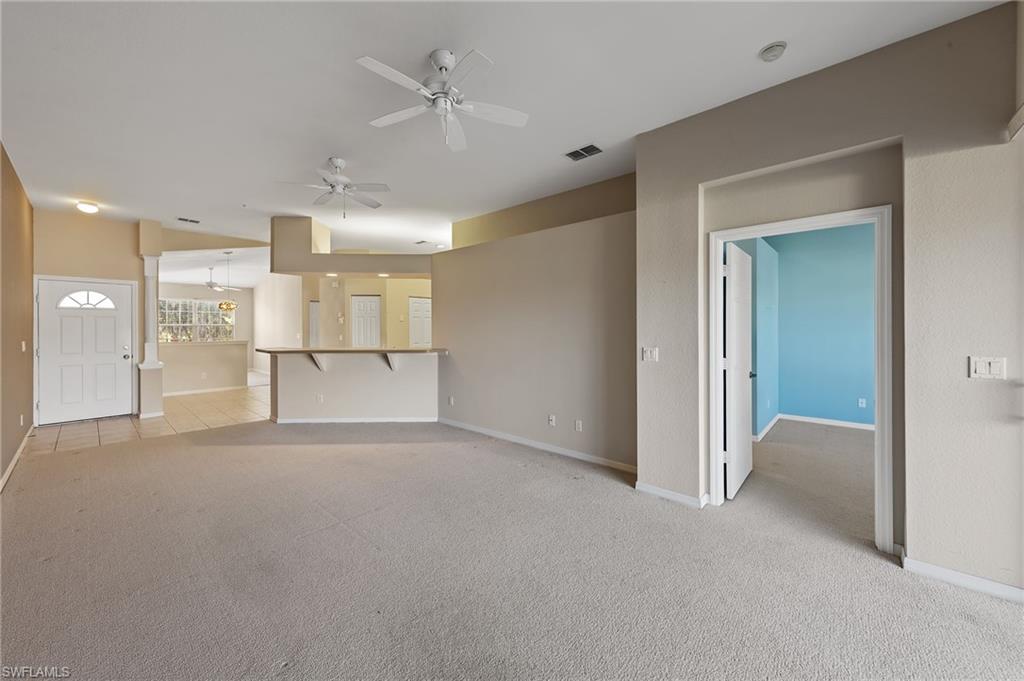 23810 Costa Del Sol Road, Unit 203 Estero, FL 34135 - Photo 16 of 48 Spare room with light carpet and ceiling fan
