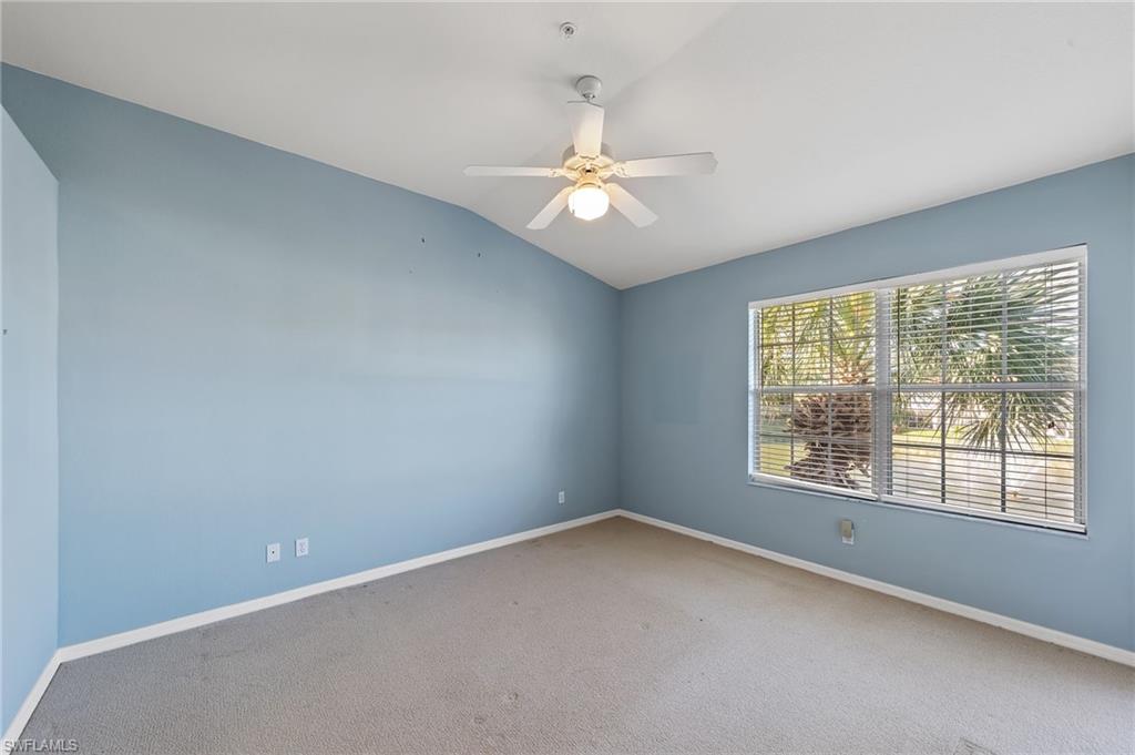 23810 Costa Del Sol Road, Unit 203 Estero, FL 34135 - Photo 21 of 48 Carpeted empty room with lofted ceiling and a ceiling fan