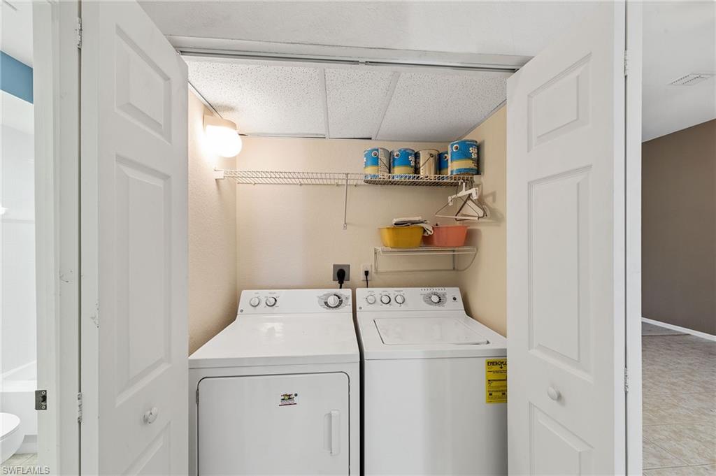 23810 Costa Del Sol Road, Unit 203 Estero, FL 34135 - Photo 29 of 48 Washroom featuring washing machine and dryer and a drop ceiling
